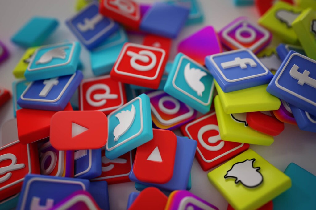 a pile of social media icon tiles, that include youtube, twitter, facebook, pintrest, and instagram